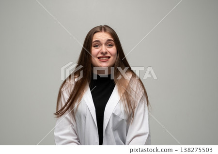 Young woman feeling awkward, cringing with nervous expression, doubtful emotion, having regret, unsure feeling Young woman feeling awkward, cringing with nervous expression, doubtful emotion, having regret, unsure feeling 138275503
