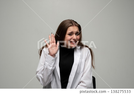 Young woman feeling disgust and aversion, showing a stop gesture with her hand, a cringing facial expression 138275533