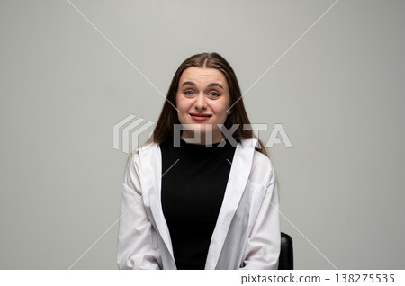 Young woman looking uncertain and hesitant, expressing doubt or confusion with a questioning facial expression 138275535