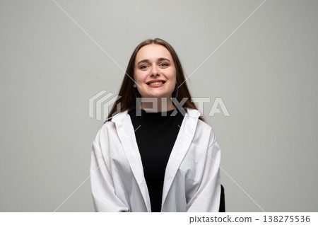 Young woman smiling broadly, expressing happiness and joy, looking directly at camera, natural portrait 138275536