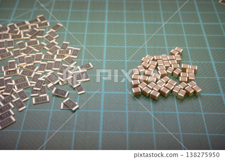 SMD electronic components comparison on green cutting mat, resistors and capacitors SMD electronic components comparison on green cutting mat, resistors and capacitors 138275950