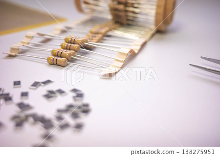 Electronic components and resistors on white background with tweezers, electronics assembly concept 138275951