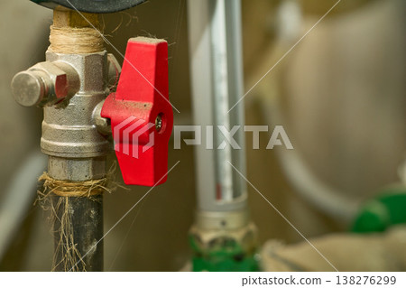 Plumbing sewerage.Valve shutting off the water tap in the basement 138276299