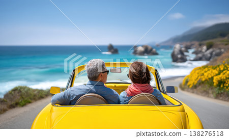 Happy senior couple driving yellow convertible car on coastal road trip 138276518