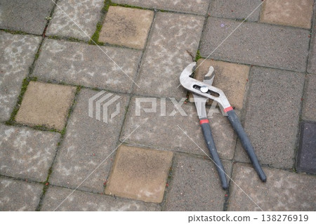Adjustable pliers or plumbing pliers or adjustable wrench. Universal tool for gripping and clamping Adjustable pliers or plumbing pliers or adjustable wrench. Universal tool for gripping and clamping 138276919