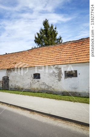 An old farm building in the village, by the road. 138277414