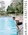Southeast Asian man jumping into a swimming pool outdoors 138277561