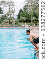Man diving into swimming pool on a relaxing day 138277562