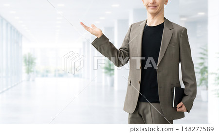 A male businessman giving directions with his hand. 138277589