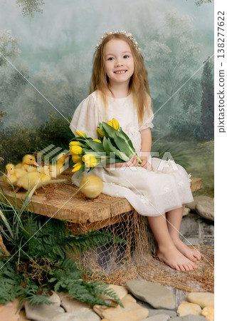 Smiling girl holding yellow tulips flowers with ducklings, spring nature portrait with soft green background Smiling girl holding yellow tulips flowers with ducklings, spring nature portrait with soft green background 138277622