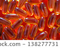 Top view of fish oil capsules on red background forming a bright pattern. Omega 3 supplements and healthcare concept. 138277731