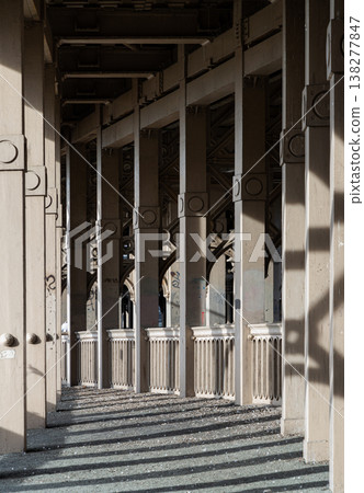 In a sweeping display of 19th-century elegance, the bridge's skeletal arches form a vaulted promenade that stretches toward the horizon. The play of afternoon light filters through the rhythmic iron In a sweeping display of 19th-century elegance, the bridge's skeletal arches form a vaulted promenade that stretches toward the horizon. The play of afternoon light filters through the rhythmic iron 138277847