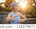 Happy mindful senior asian woman practicing yoga outdoors 138279671