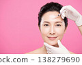Middle aged woman receiving a cosmetic injection for beauty on her forehead 138279690