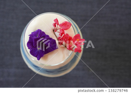 top view butterfly pea milk decorated with purple butterfly pea flowers and a red flowers branch in a clear glass placed on a cloth background, drink, food, health, copy space top view butterfly pea milk decorated with purple butterfly pea flowers and a red flowers branch in a clear glass placed on a cloth background, drink, food, health, copy space 138279746