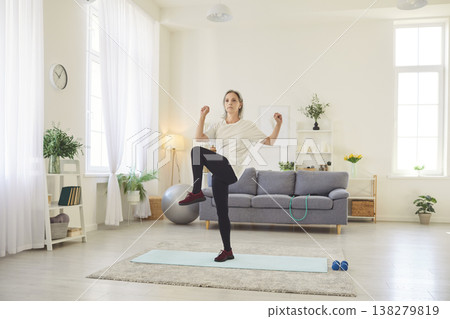 Senior Woman Doing Stretching Exercises at Home for Fitness and Health Senior Woman Doing Stretching Exercises at Home for Fitness and Health 138279819