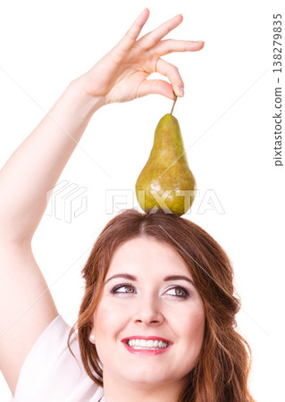 Woman holding pear fruit on head. Healthy diet. Woman holding pear fruit on head. Healthy diet. 138279835