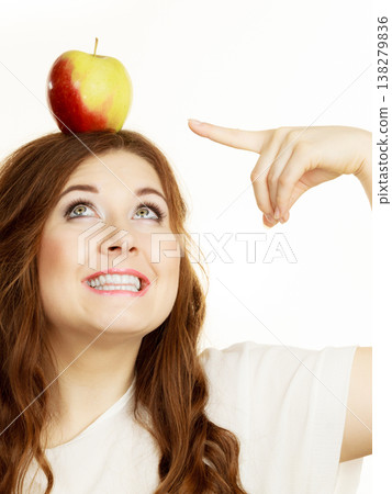 Woman funny girl holds on head apple fruit Woman funny girl holds on head apple fruit 138279836
