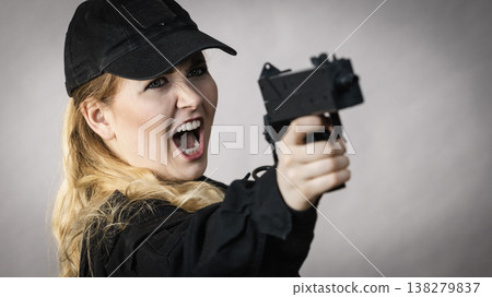 Woman holds gun in hands. Woman holds gun in hands. 138279837