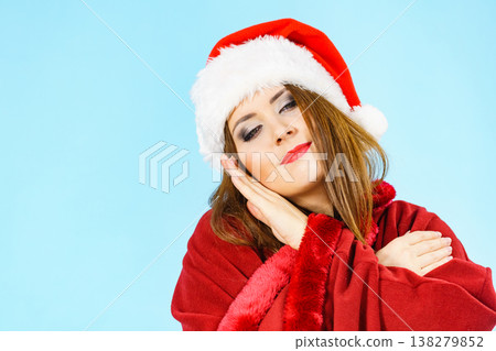 Woman in santa hat being sleepy Woman in santa hat being sleepy 138279852