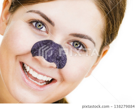 Woman applying pore strips on nose 138279884