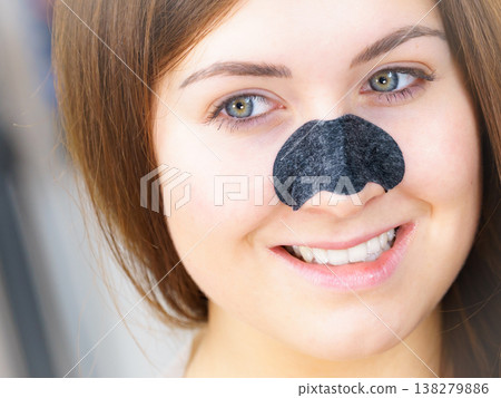 Female with nose mask pore strips Female with nose mask pore strips 138279886