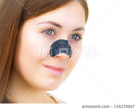 Woman applying pore strips on nose 138279887