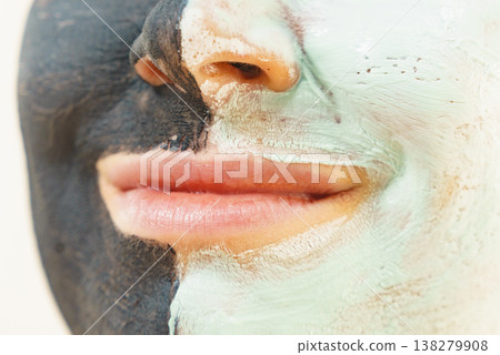 Girl black and green mud mask on face Girl black and green mud mask on face 138279908