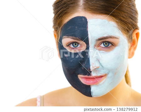Girl with black white mud mask on face Girl with black white mud mask on face 138279912
