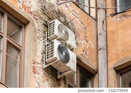 air conditioning on facade of building, air cooling in hot weather. air conditioning on facade of building, air cooling in hot weather. 138279940