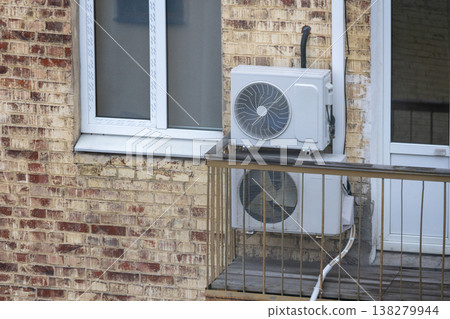 air conditioning on facade of building, air cooling in hot weather. air conditioning on facade of building, air cooling in hot weather. 138279944