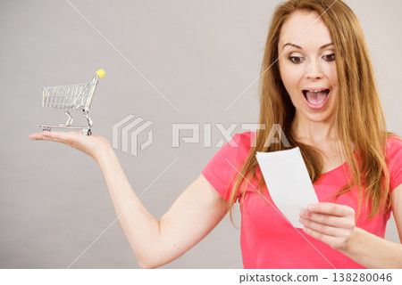 Woman with bill and shopping cart 138280046