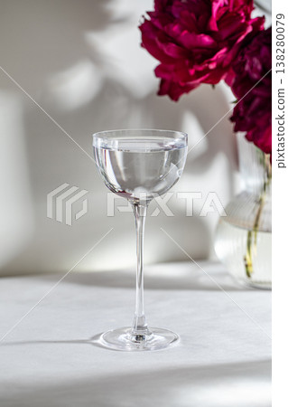 Clear cocktail glass with flowers in soft light Clear cocktail glass with flowers in soft light 138280079
