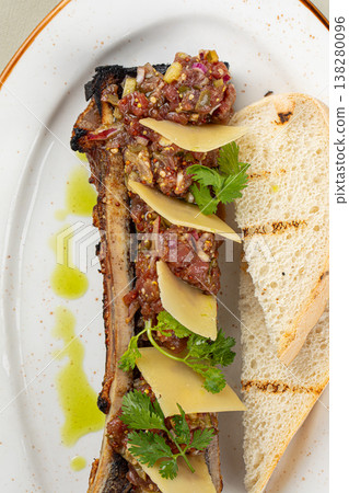 Bone marrow with beef tartare and bread slices Bone marrow with beef tartare and bread slices 138280096