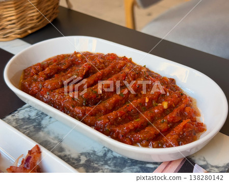 Spicy Turkish ezme spread served in a white dish with rich red pepper and tomato texture. Traditional meze appetizer, restaurant menu presentation and savory condiment for grilled dishes Spicy Turkish ezme spread served in a white dish with rich red pepper and tomato texture. Traditional meze appetizer, restaurant menu presentation and savory condiment for grilled dishes 138280142