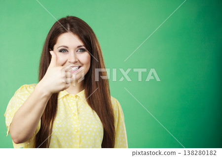 Woman making thumb up gesture 138280182