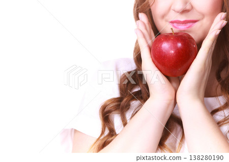 Woman holding apple fruit close to face 138280190