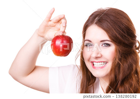 Woman holds apple fruit close to face, isolated 138280192