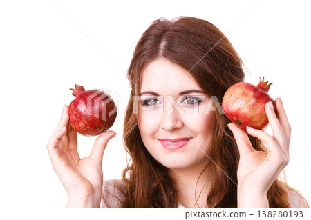 Cheerful woman holds pomegranate fruits, isolated Cheerful woman holds pomegranate fruits, isolated 138280193