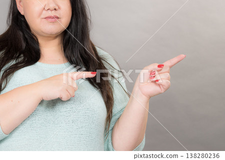 Woman pointing at copy space Woman pointing at copy space 138280236