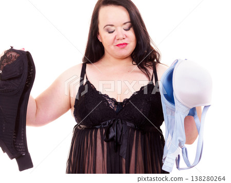 Woman choosing witch bra to wear. Woman choosing witch bra to wear. 138280264