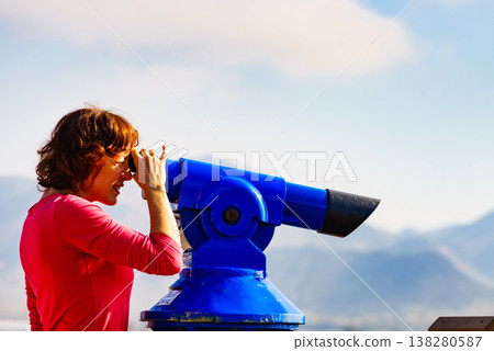 Woman using tourist binoculars, Cabo de Gata, Spain 138280587