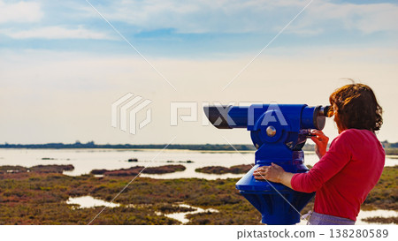 Woman using tourist binoculars, Cabo de Gata, Spain Woman using tourist binoculars, Cabo de Gata, Spain 138280589
