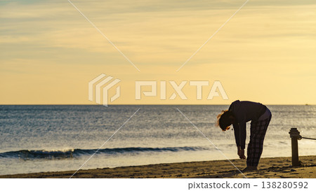 Woman exercising on beach at morning. Woman exercising on beach at morning. 138280592