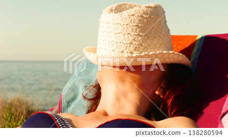 Tourist woman on beach enjoying vacation Tourist woman on beach enjoying vacation 138280594