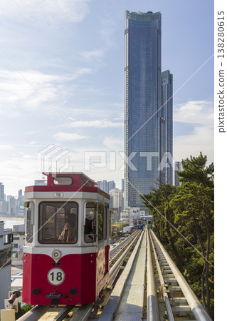 Busan, South Korea - 02 Sep, 2025 - Haeundae LCT The Sharp Landmark Tower standing over a hillside transit line as colorful capsule cars move along elevated tracks in bright, clear daylight. High Busan, South Korea - 02 Sep, 2025 - Haeundae LCT The Sharp Landmark Tower standing over a hillside transit line as colorful capsule cars move along elevated tracks in bright, clear daylight. High 138280615