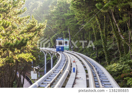 Colorful oceanfront capsule cars travel along an elevated coastal rail, offering scenic seaside views and a relaxed tourism experience over the water. High quality photo Colorful oceanfront capsule cars travel along an elevated coastal rail, offering scenic seaside views and a relaxed tourism experience over the water. High quality photo 138280885