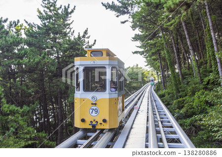 Colorful oceanfront capsule cars travel along an elevated coastal rail, offering scenic seaside views and a relaxed tourism experience over the water. High quality photo Colorful oceanfront capsule cars travel along an elevated coastal rail, offering scenic seaside views and a relaxed tourism experience over the water. High quality photo 138280886