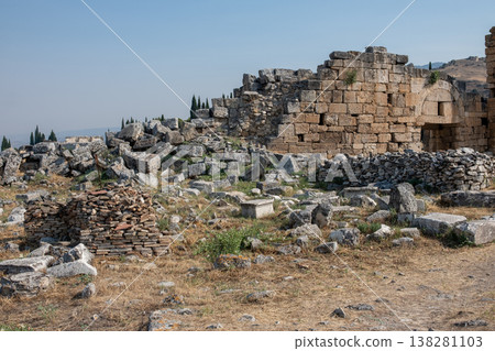 Exploring Ancient Ruins of Pamukkale Under Clear Blue Skies With Limestone Formations Surrounding the Historical Site Exploring Ancient Ruins of Pamukkale Under Clear Blue Skies With Limestone Formations Surrounding the Historical Site 138281103