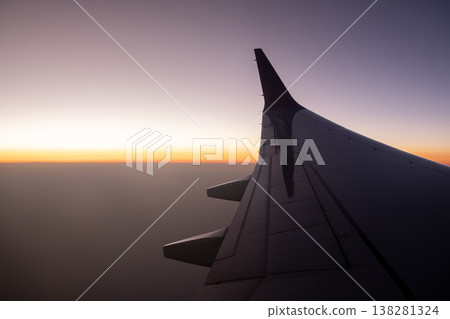 Sunset View From an Airplane Wing Over a Vast Sky During Twilight Hours Sunset View From an Airplane Wing Over a Vast Sky During Twilight Hours 138281324